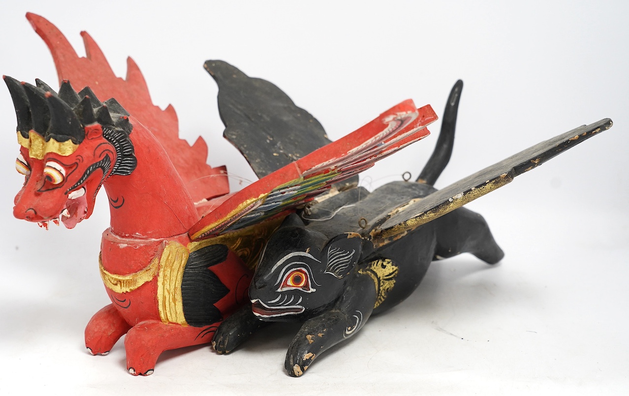 Two Balinese carved and painted wood winged creatures, largest 44cm long. Condition - fair